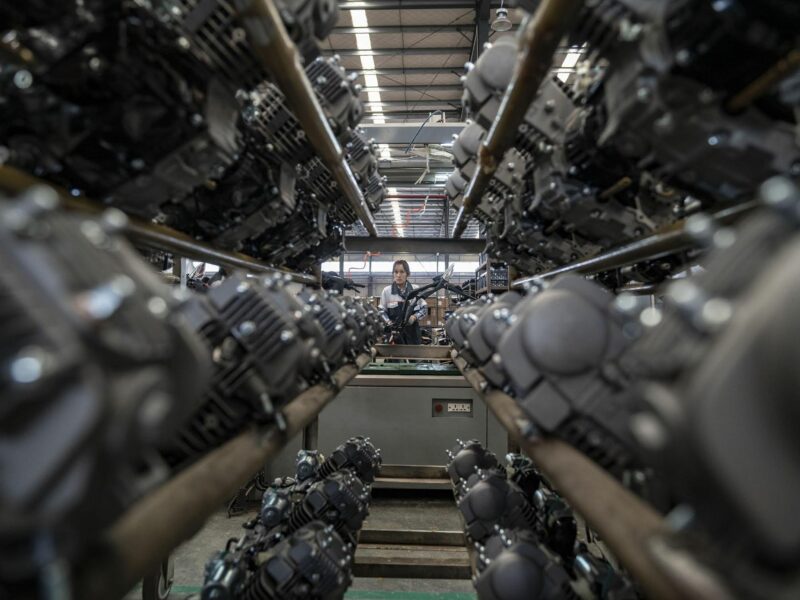 Photo of a woman working at a motorbike factory in China's Yunnan Province.