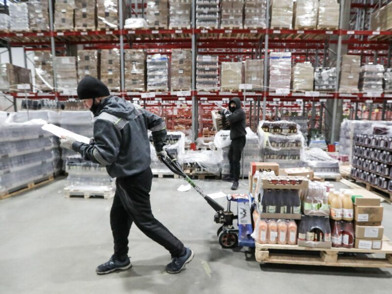 Photo of a worker collecting goods in a warehouse for an online order at a Veshki distribution center for the food retailer VkusVill, a chain of Russian grocery stores.