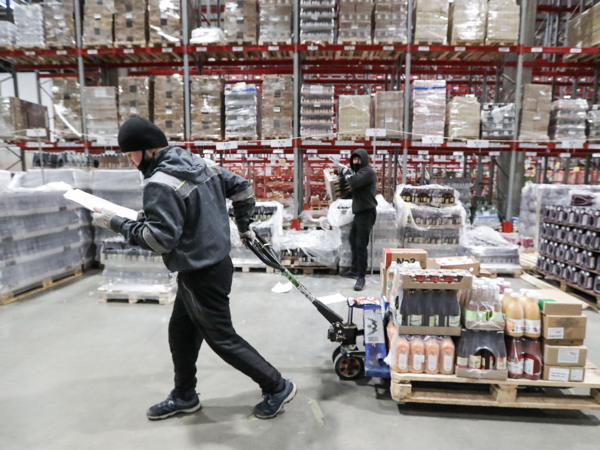 Photo of a worker collecting goods in a warehouse for an online order at a Veshki distribution center for the food retailer VkusVill, a chain of Russian grocery stores.