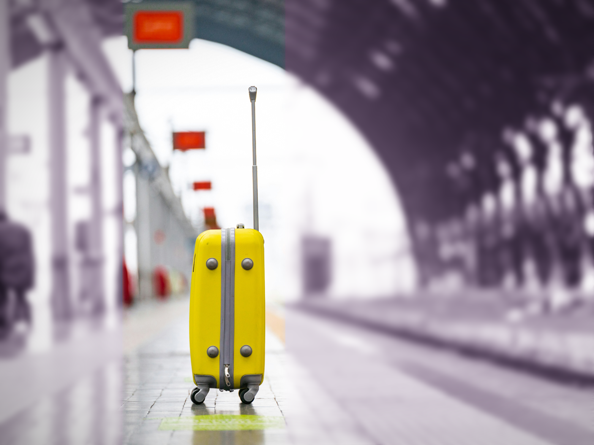 Photo of a yellow suitcase on a train platform in Milan, Italy