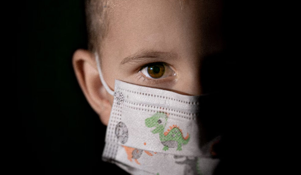 Photo of a young children wearing a protective mask