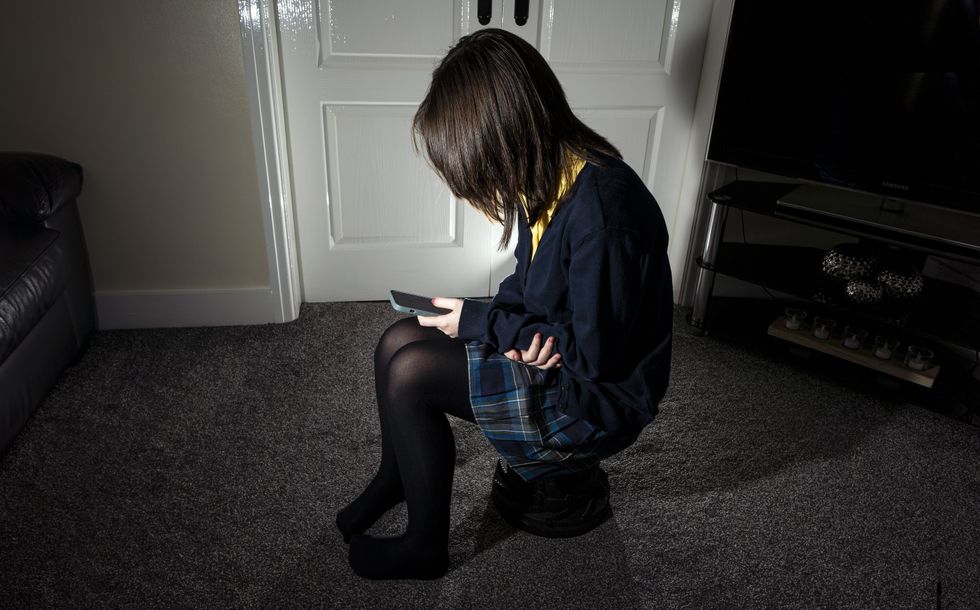 Photo of a young girl using a mobile phone