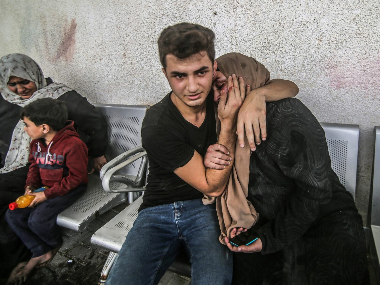 photo of a young man comforting his mother