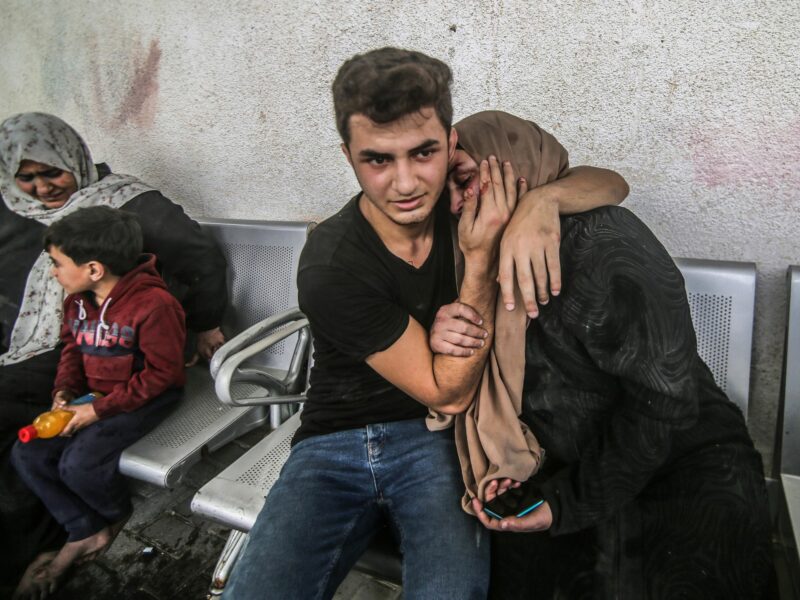 photo of a young man comforting his mother