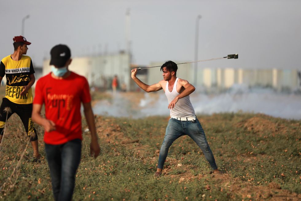 photo of a young man using a slingshot