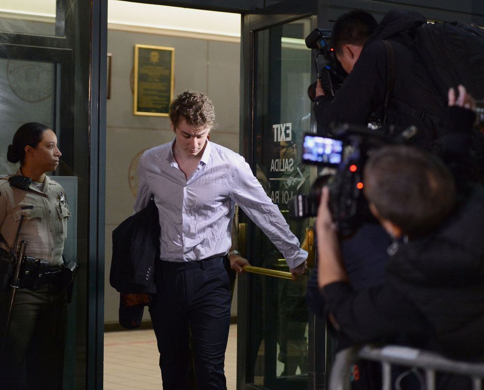photo of a young man walking through a door