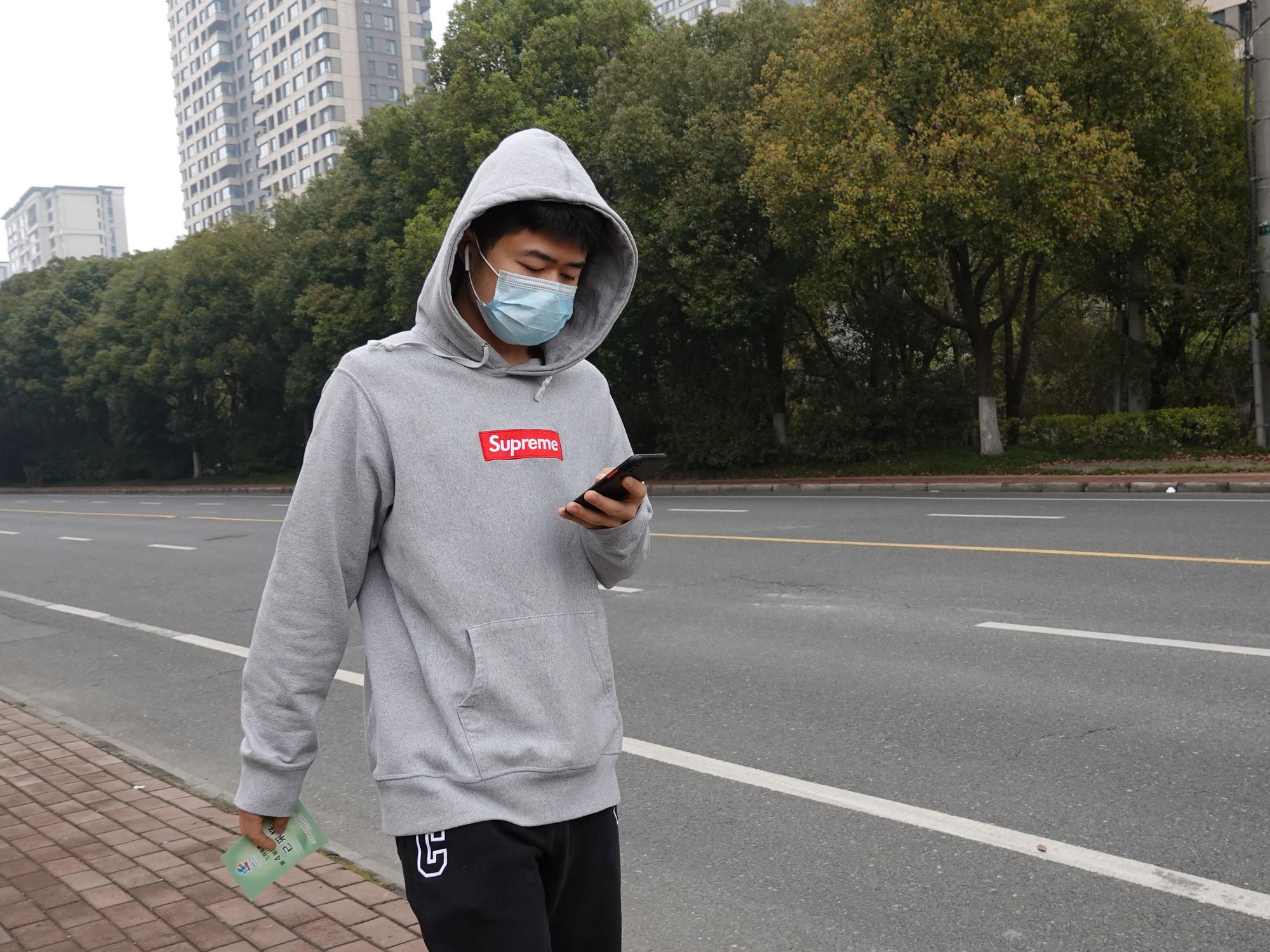 Photo of a young man wearing a COVID-19 protective mask, walking in Changzhou, China, on March 19​