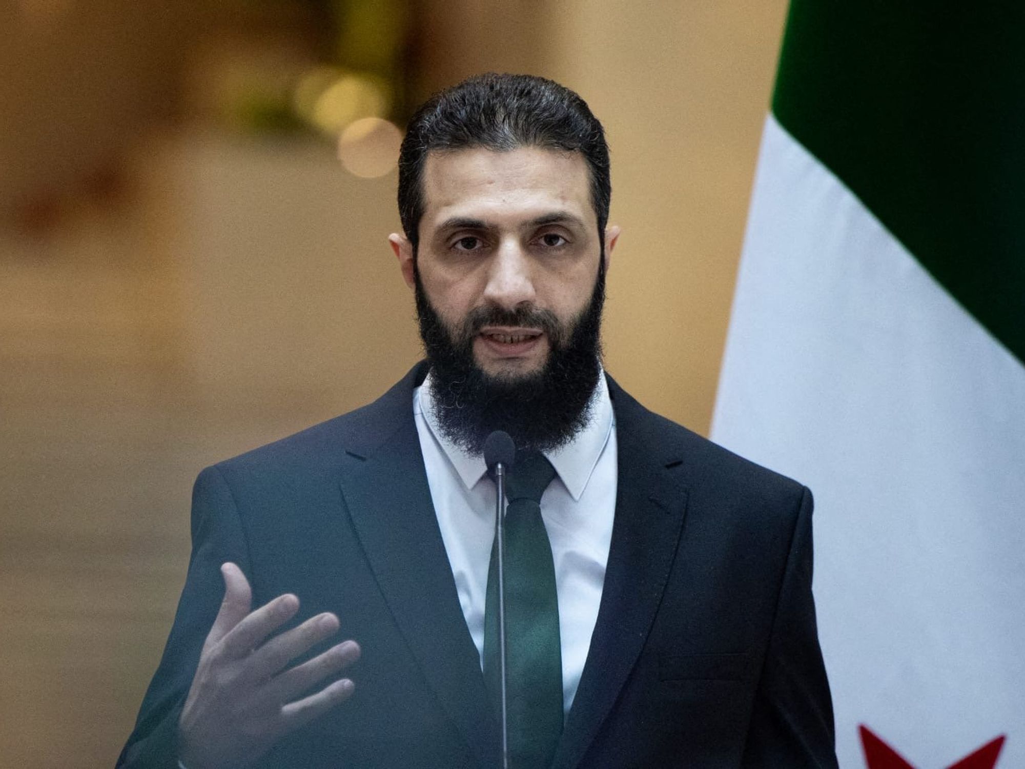 Photo of Ahmed al-Sharaa speaking at a Press Conference in Damascus