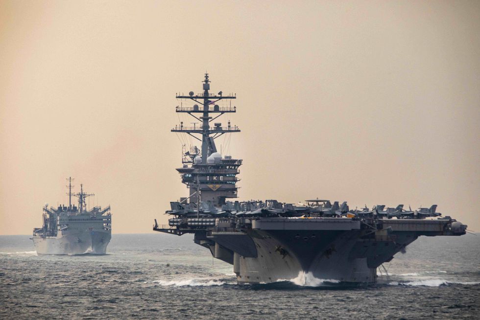 Photo of aircraft carrier and another ship in the open waters