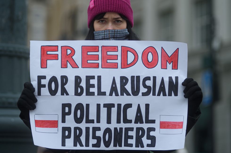 Photo of an activist holding a placard in support of Belarusian political prisoners during a demonstration in Vilnius, Lithuania, on Jan. 28