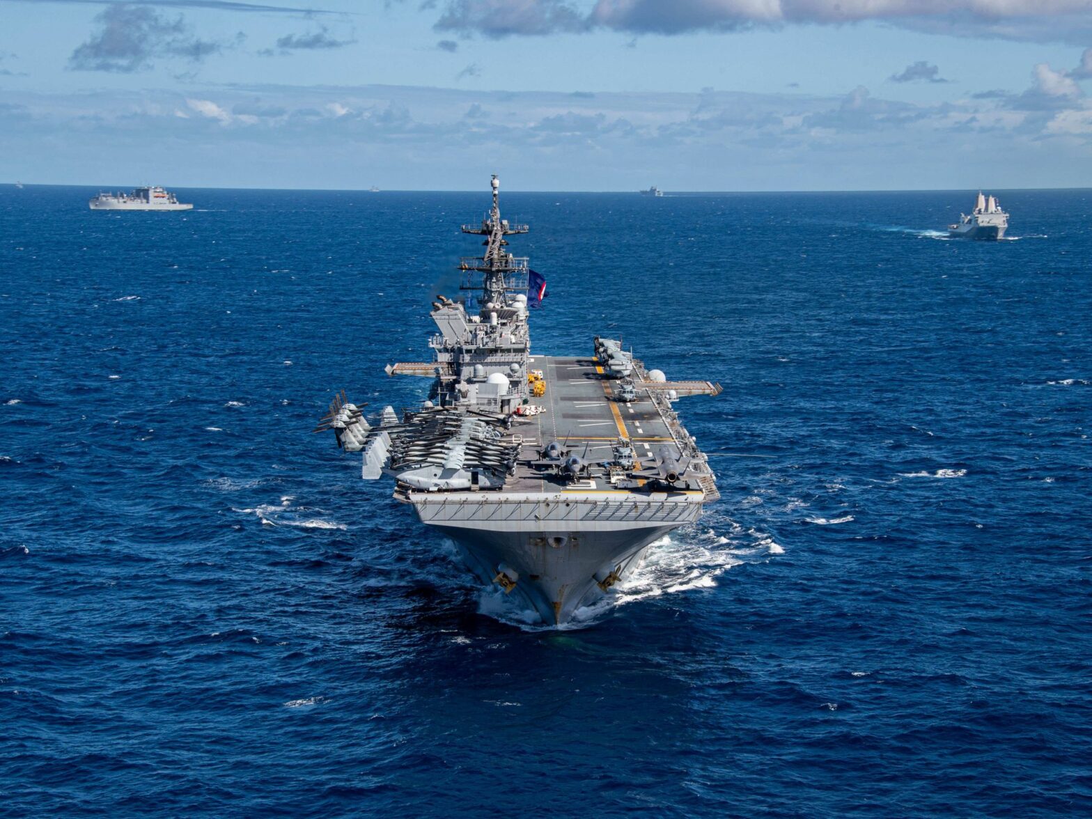 photo of an aircraft carrier in blue seas