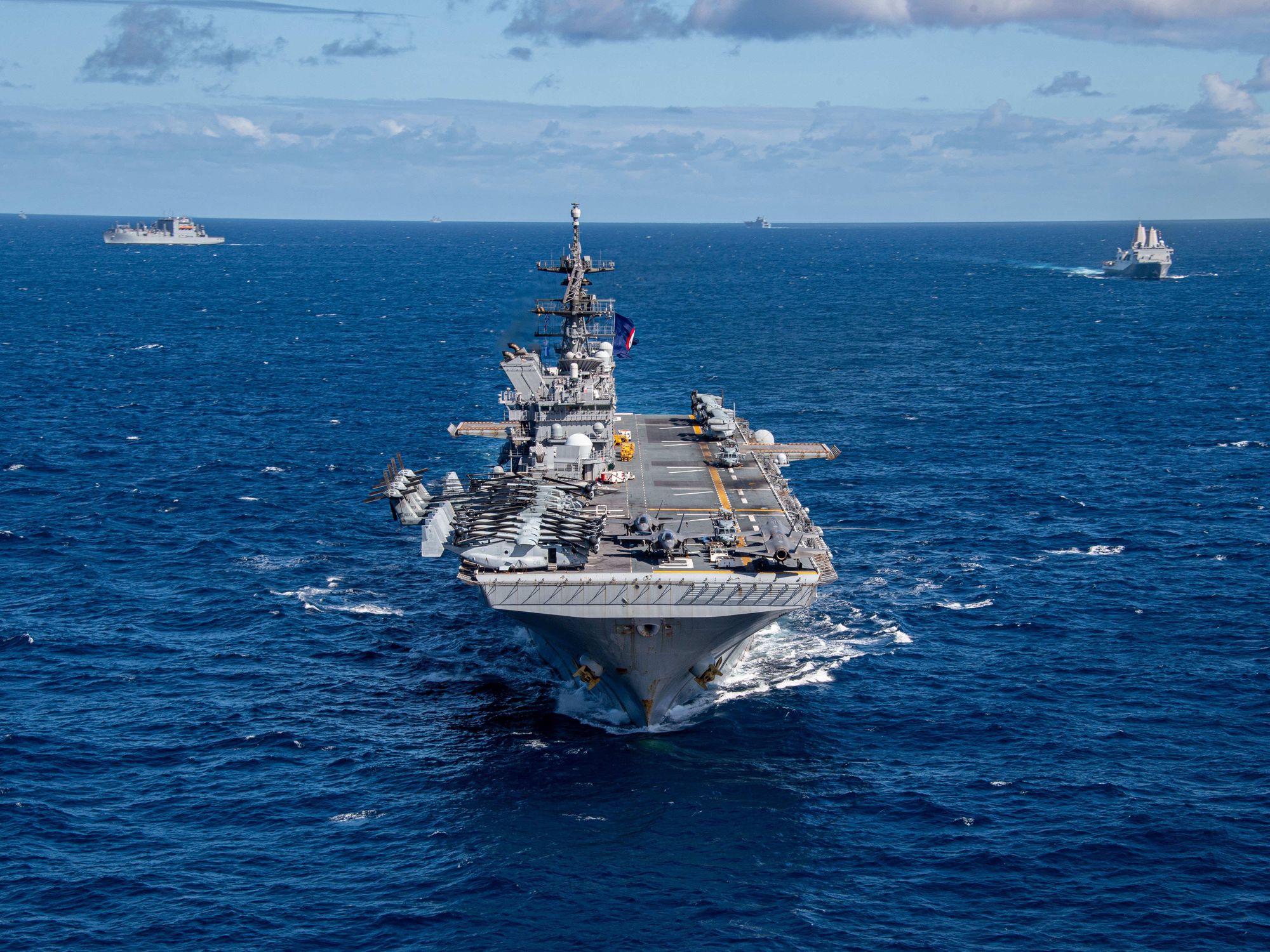 photo of an aircraft carrier in blue seas