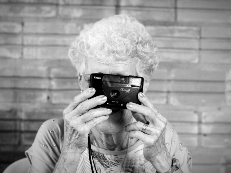 Photo of an elderly lady taking a photograph