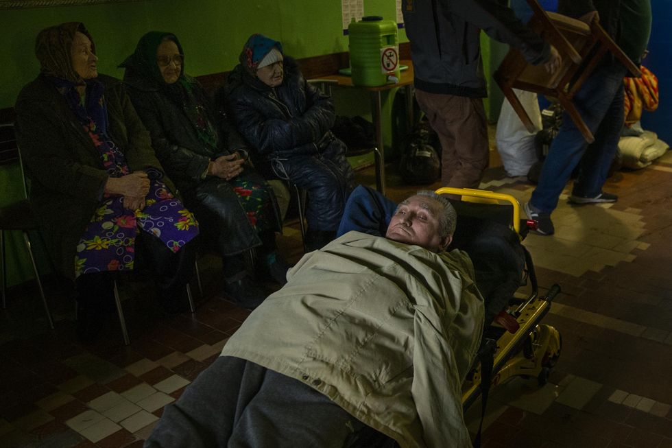 Photo of an elderly resident at care center, waiting on a gurney to be evacuated from Toretsk, Ukraine, on April 13