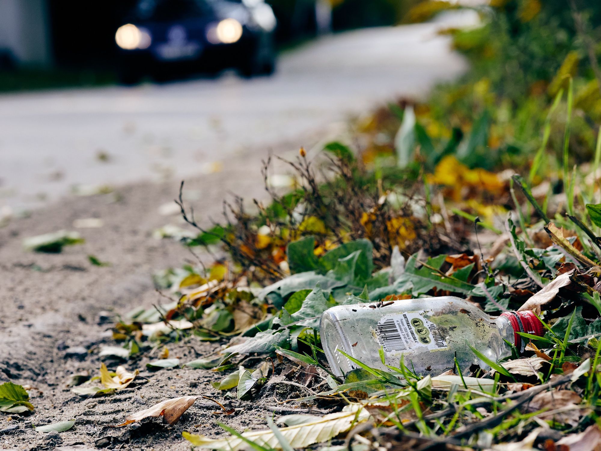 Photo of an empty vodka bottle on the ground in Poland