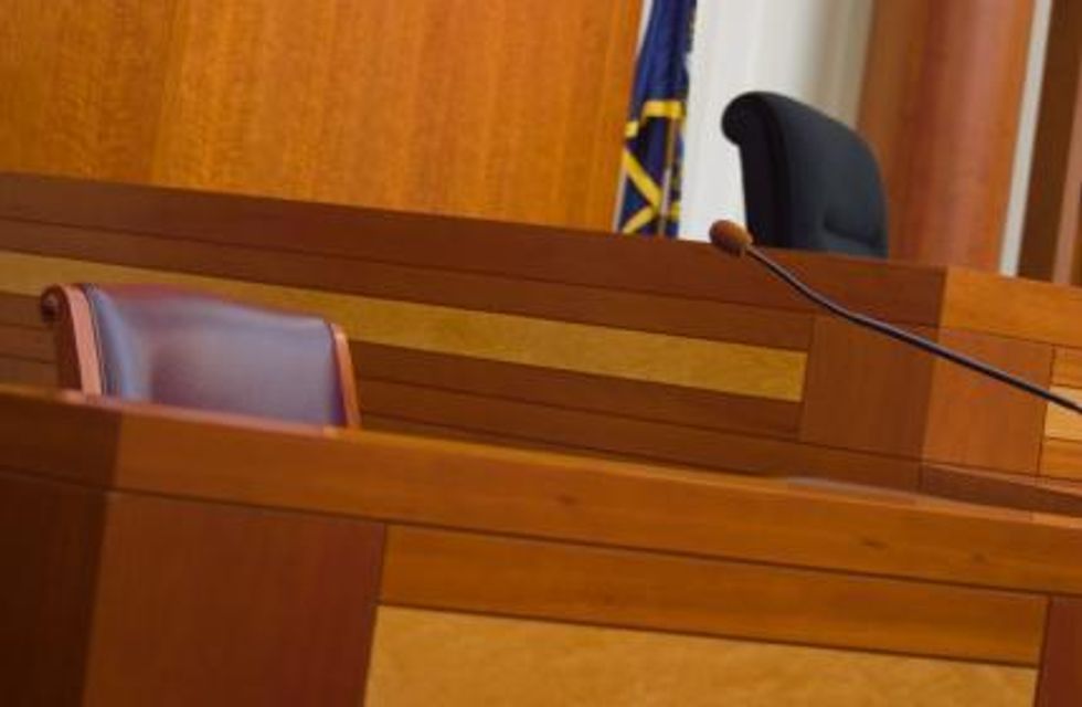 Photo of an empty witness stand in a courtroom