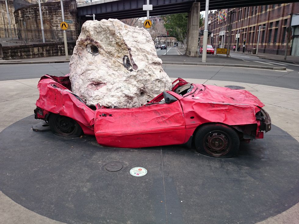 Photo of an illusion of a rock crushing a car in Sydney Australia