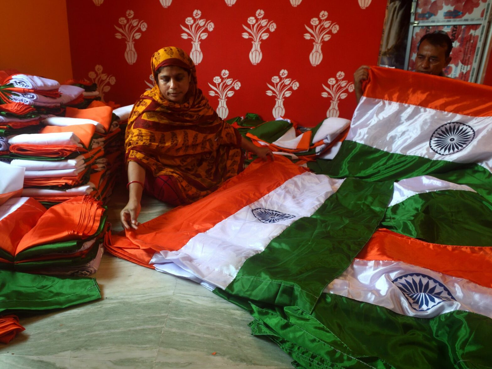 Photo of an Indian woman sitting with Indian flags