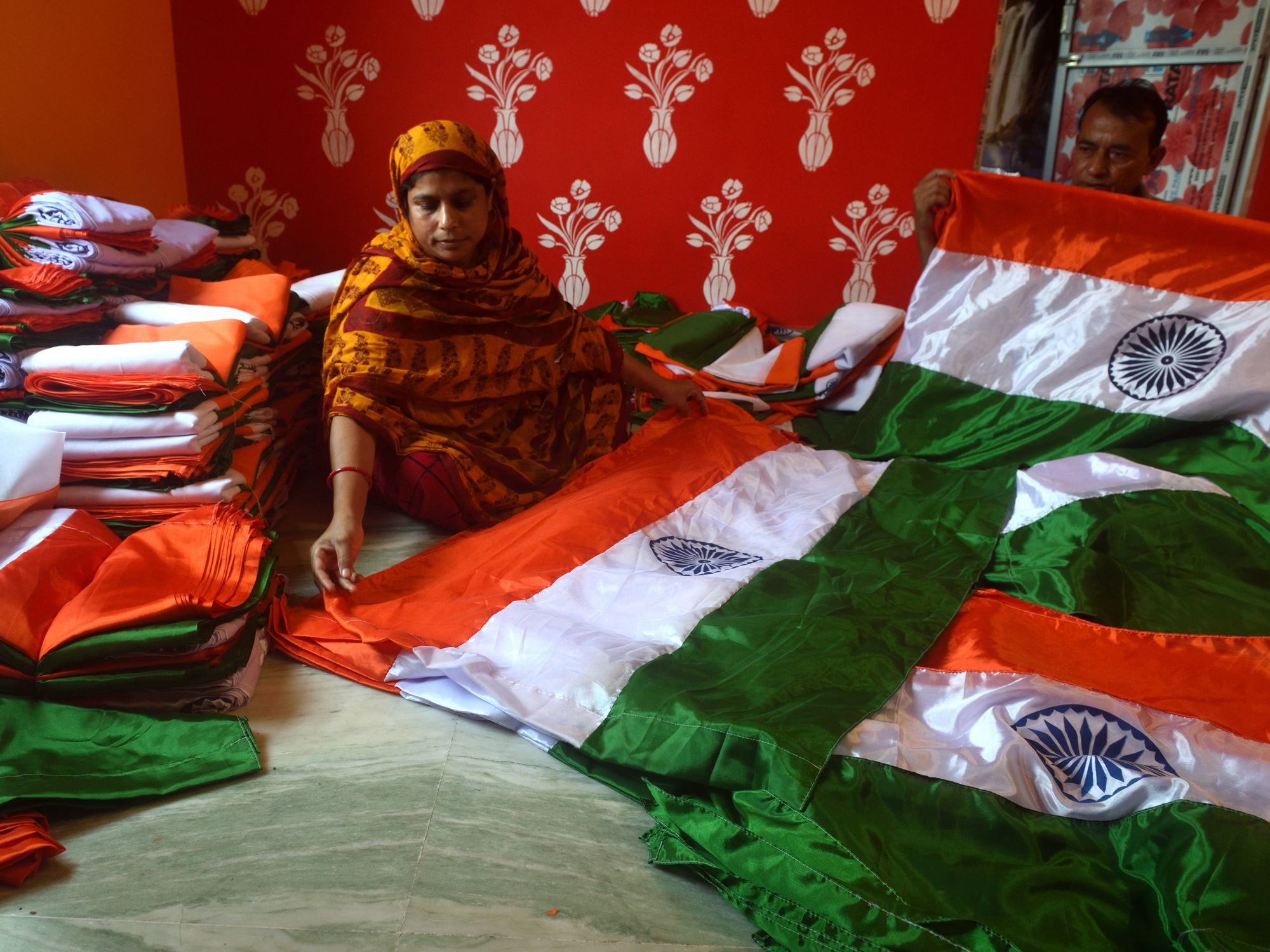 Photo of an Indian woman sitting with Indian flags