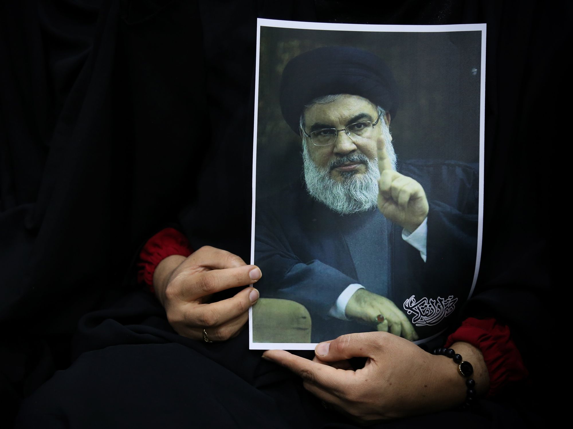 Photo of an Iranian woman holding a portrait of the Secretary-General of Hezbollah, Hassan Nasrallah, during a pro-hijab and pro-government gathering in Tehran on Nov. 2