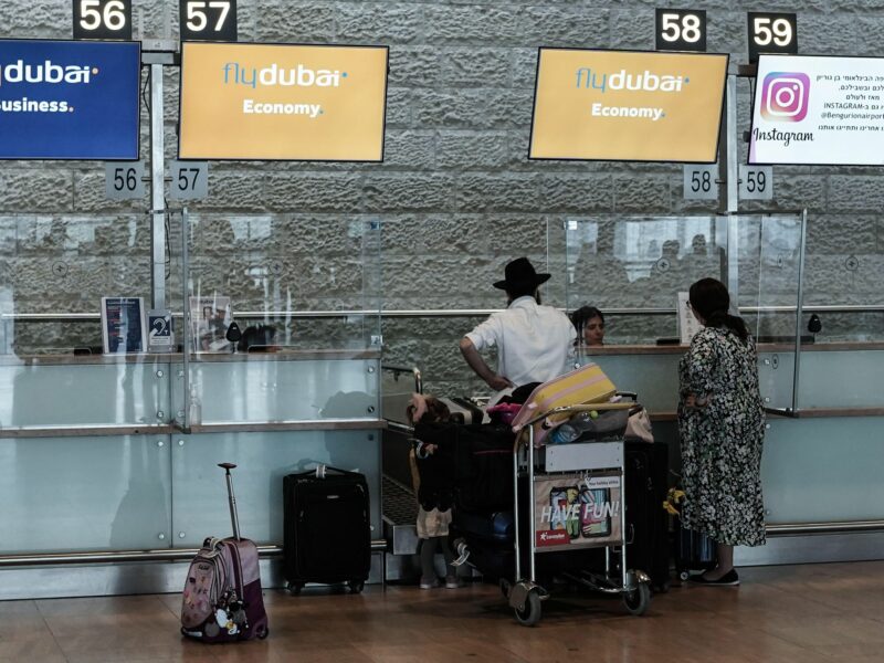 photo of an Orthodox family checking in to Dubai Airlines at Tel Aviv airport