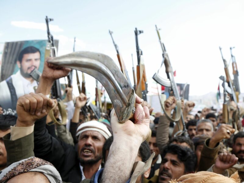 Photo of angry protestors holding rifles and knives up as part of anti-U.S. demonstrations in Sanaa, Yemen, on March 17