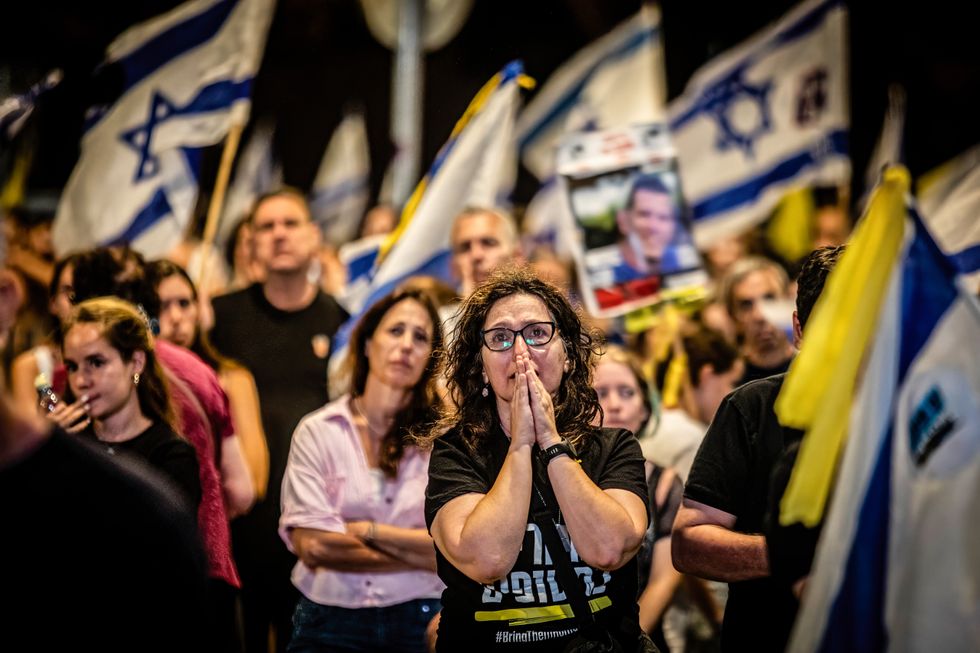 Photo of anti-government protesters crying in Tel Aviv on September 21.