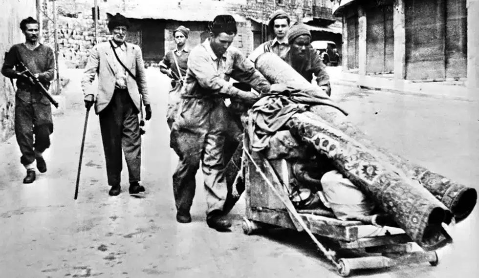 Photo of Arab residents leaving Haifa in 1948 with their belongings.