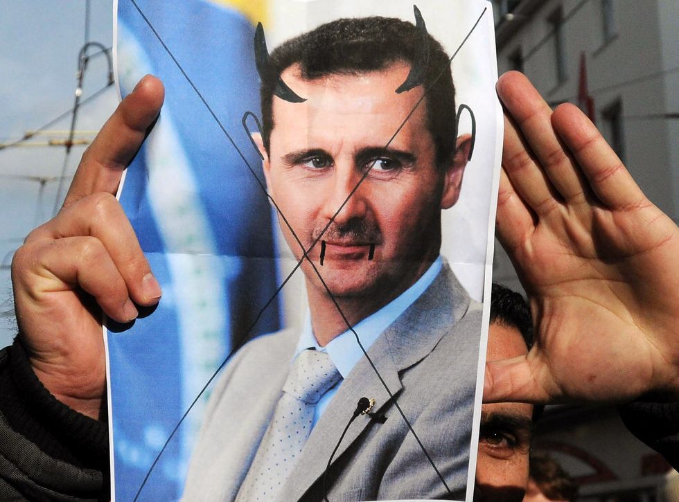photo of assad with devil horns