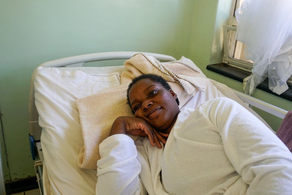 Photo of Barbara Samu, a tuberculosis patient, lying in a hospital bed.