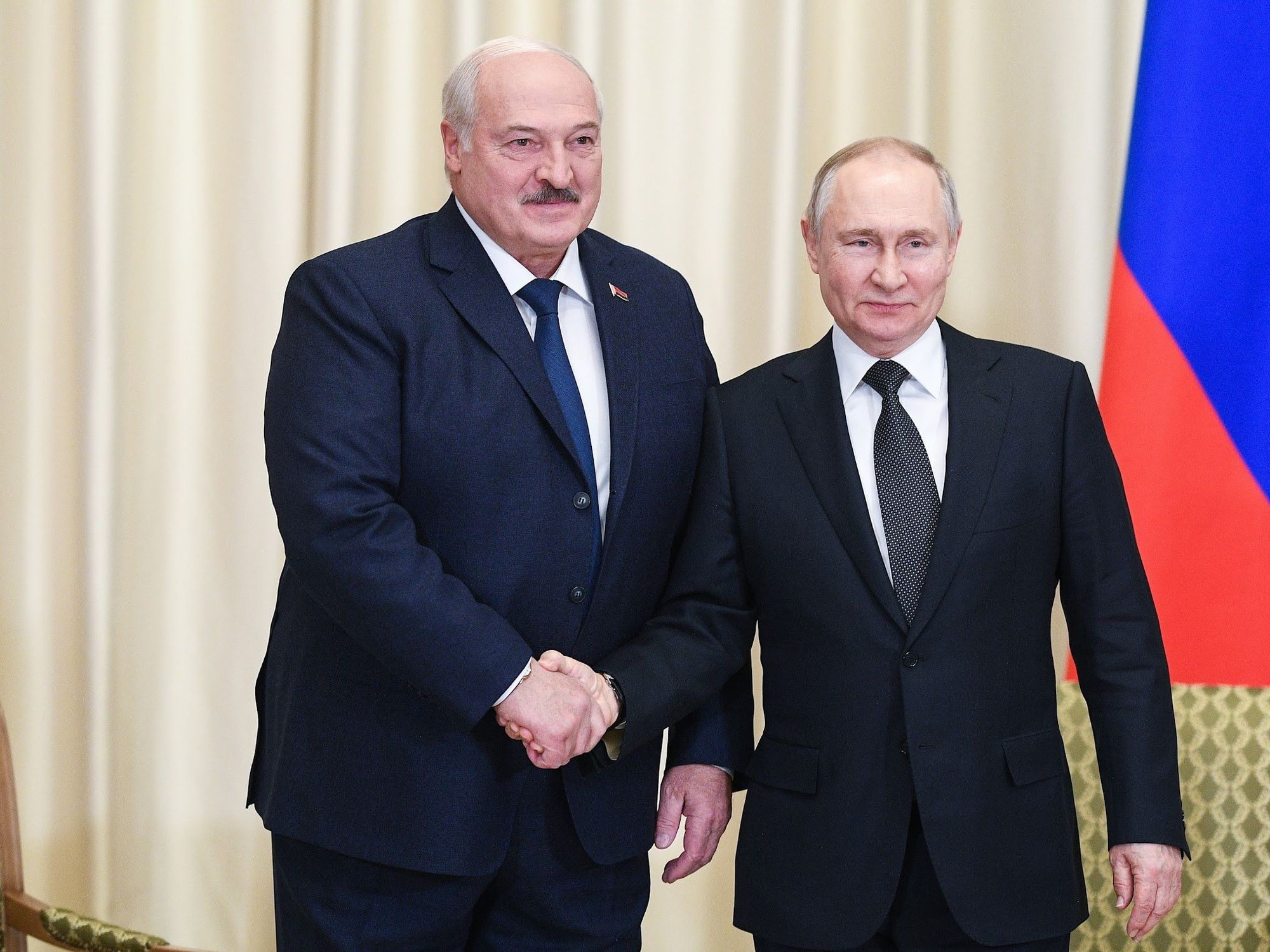 Photo of Belarusian President Alexander Lukashenko and Russia's President Vladimir Putin shaking hands as they pose for a photograph during a meeting in the Novo-Ogaryovo residence​.
