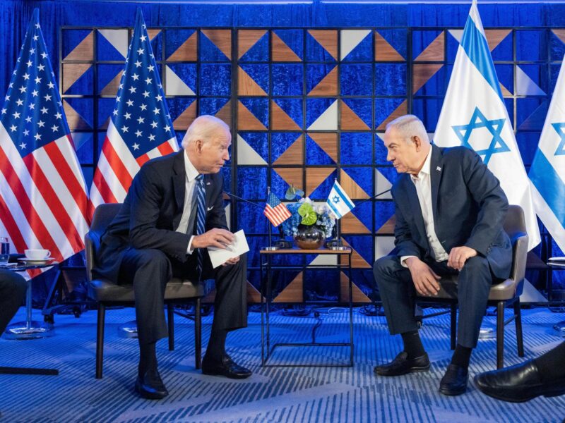 photo of biden and netanyahu leaning in to talk to each other