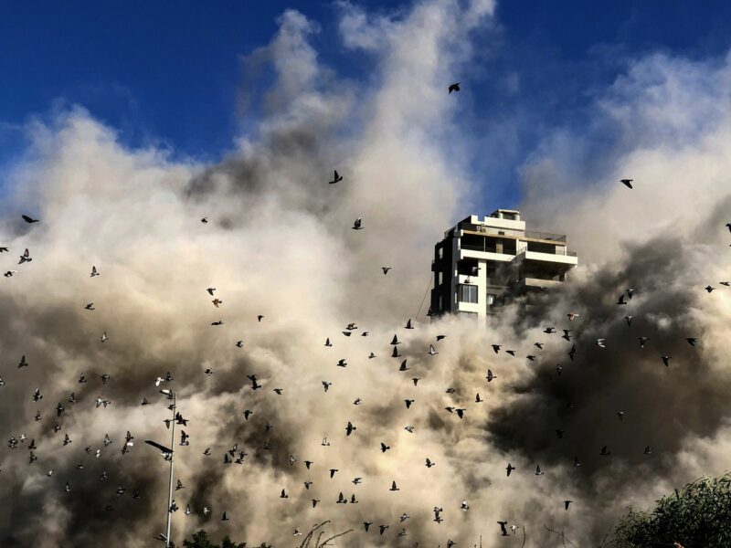 Photo of birds flying away as smoke billows from the site of an Israeli strike on Beirut, on Oct. 22.