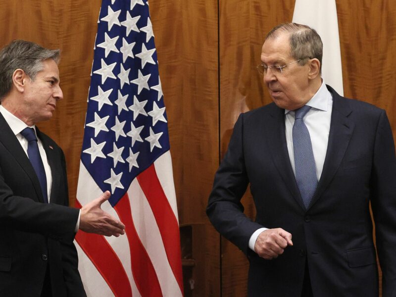 photo of Blinken reaching out to shake hands with Lavrov