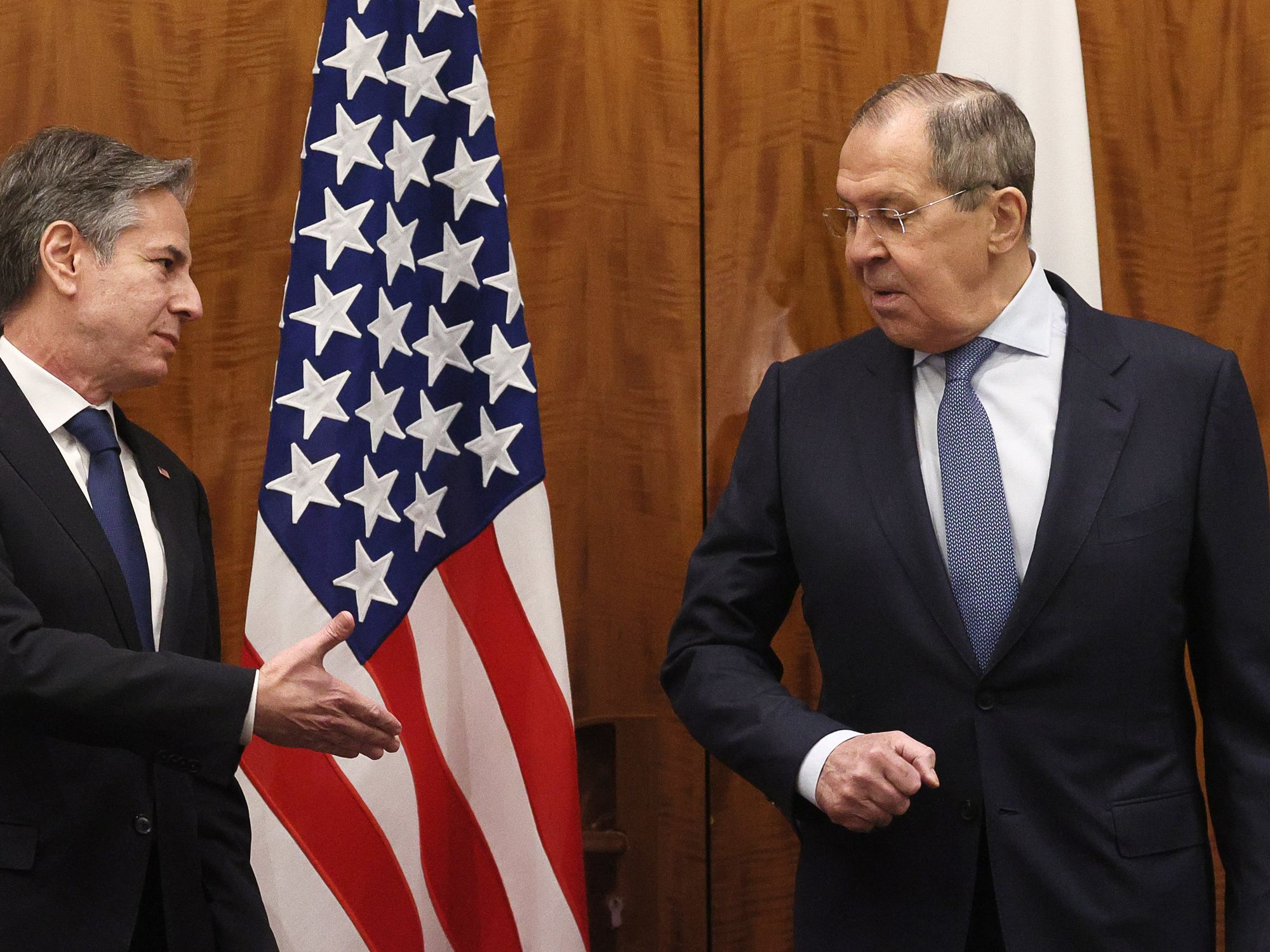 photo of Blinken reaching out to shake hands with Lavrov