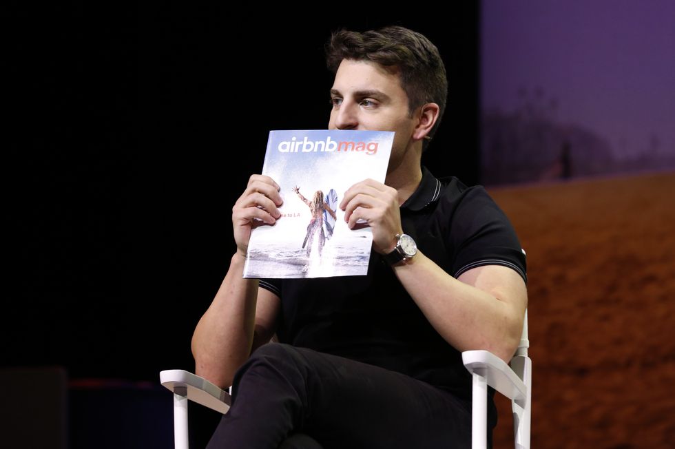 photo of Brian Chesky holding up a magazine in front of his face