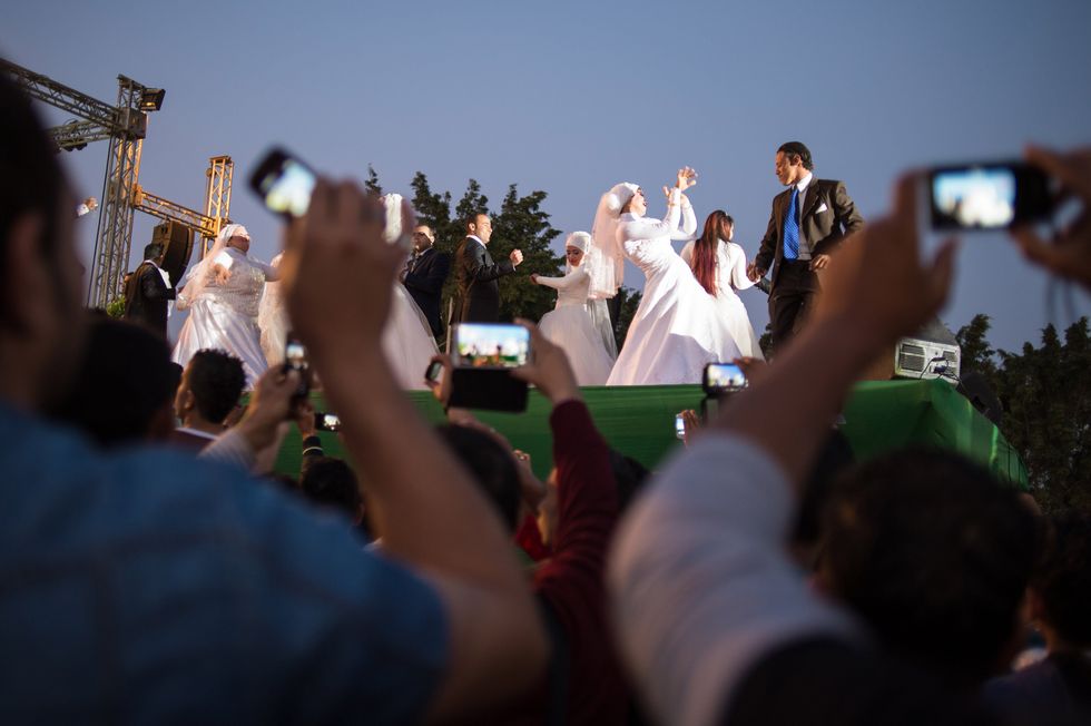 photo of brides and grooms dancing at a group wedding