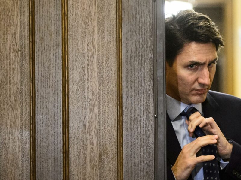 Photo of Canadian Prime Minister Justin Trudeau adjusting his tie in Ottowa.