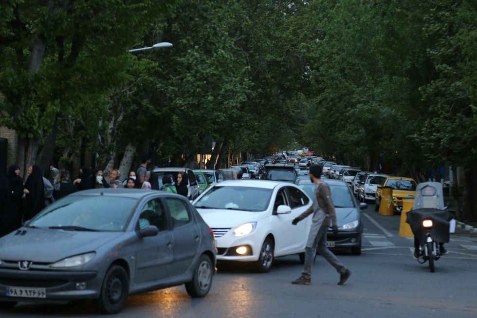 photo of cars turning a corner in Tehran