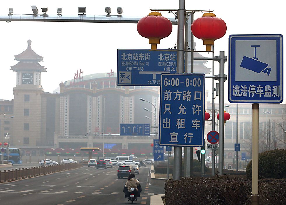 Photo of CCTV cameras watch over an intersection in downtown Beijing