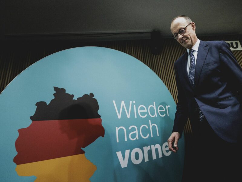 Photo of CDU/CSU leader Friedrich Merz walking onstage at a press conference in Berlin on Feb. 24.