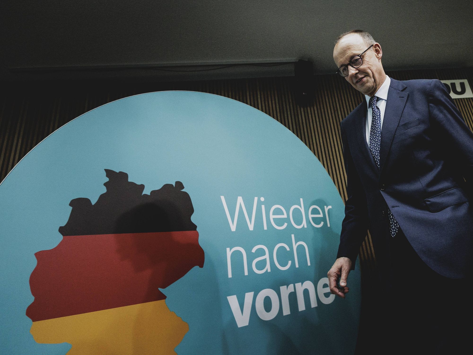 Photo of CDU/CSU leader Friedrich Merz walking onstage at a press conference in Berlin on Feb. 24.
