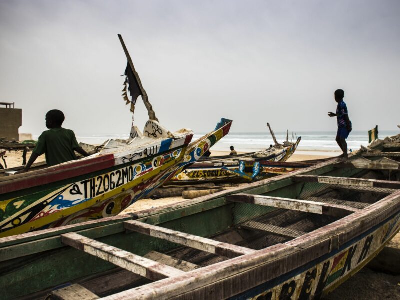 Photo of children playing in the fish market in Mboro Plage beach