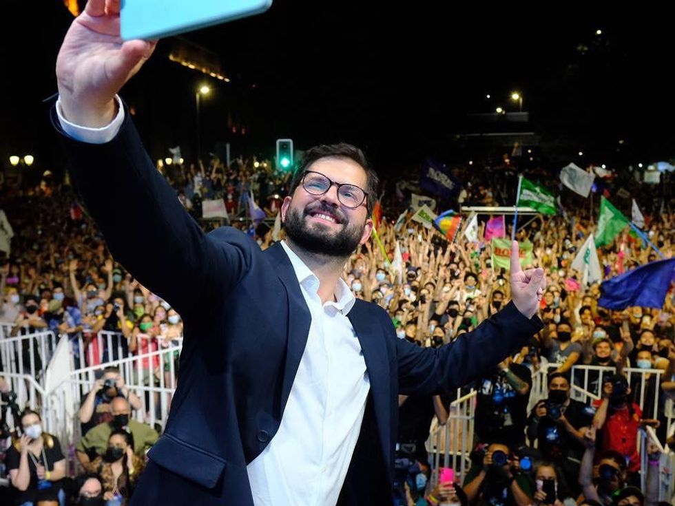 Photo of Chile's President-Elect Gabriel Boric on Dec. 20 taking a selfie in front of a crowd