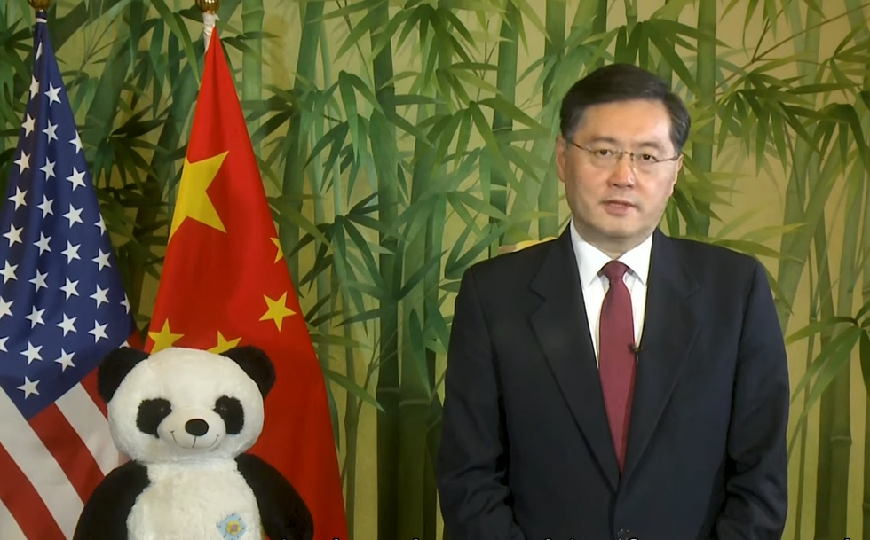 Photo of China's Foreign Minister Qin Gang next a Chinese flag and a stuffed panda