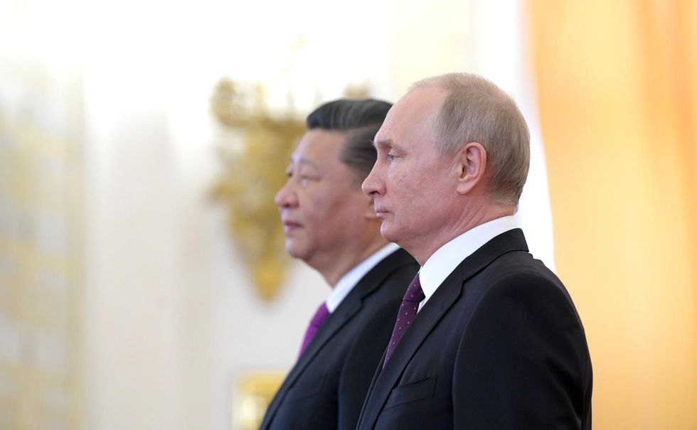 Photo of Chinese President Xi Jinping and Russian President Vladimir Putin standing side by side in 2019