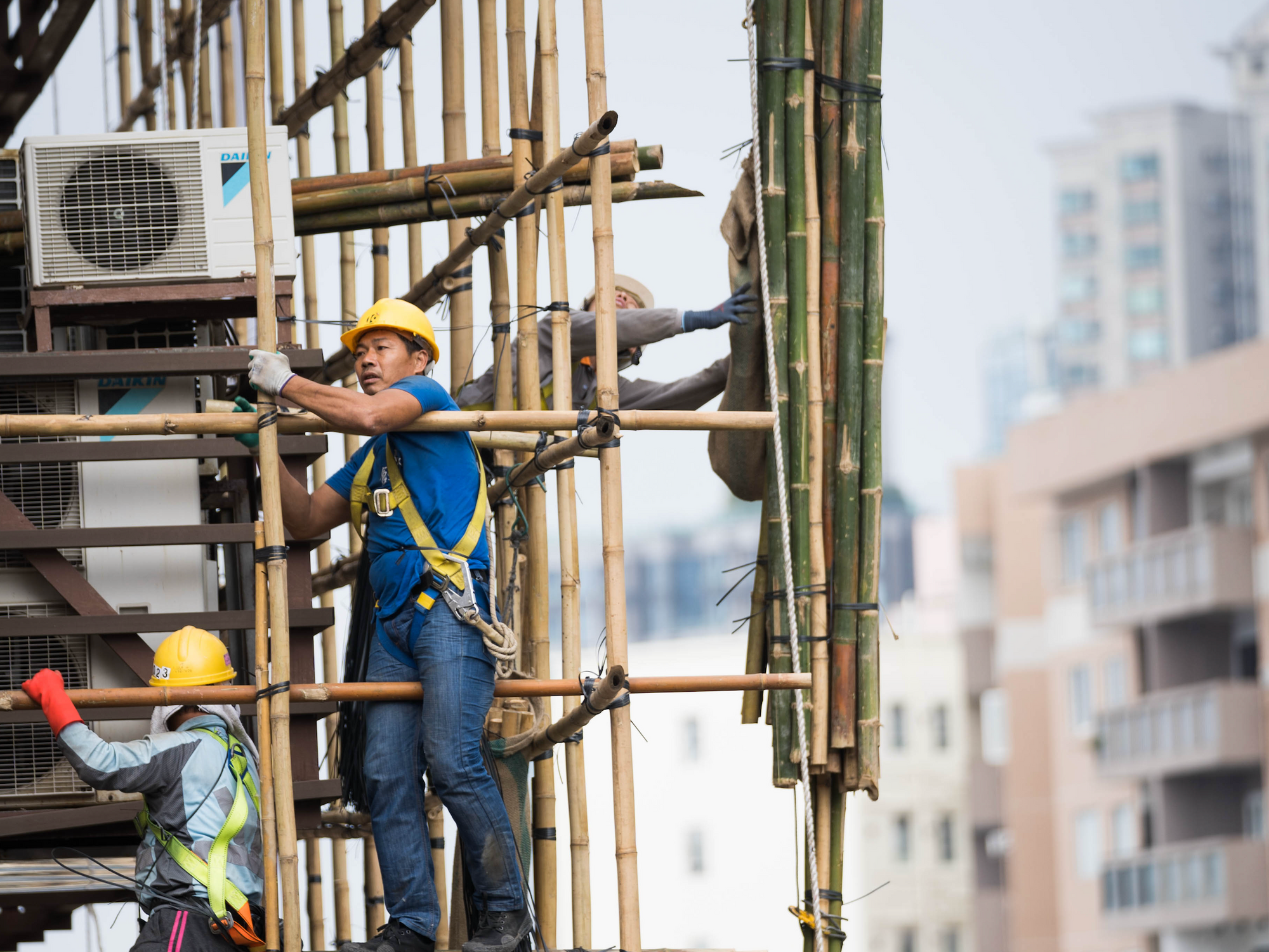 Photo of construction workers on bamboo scaffolding in Hong Kong