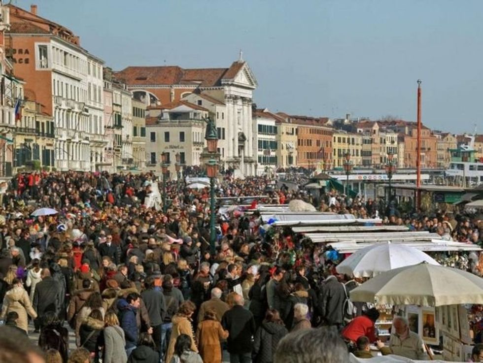 Photo of crowds of tourists in Venice, Italy.