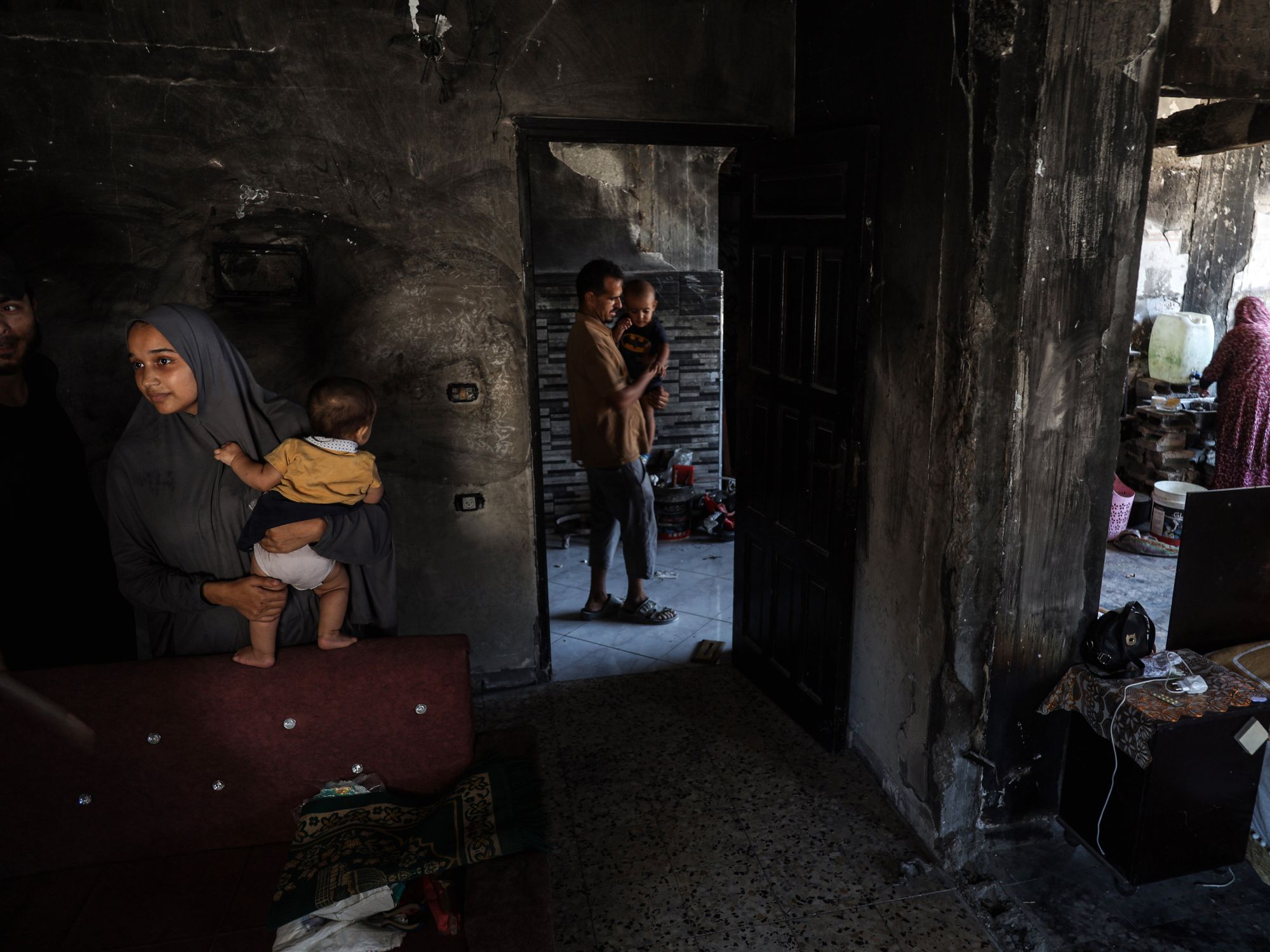 photo of different people in different rooms of a house