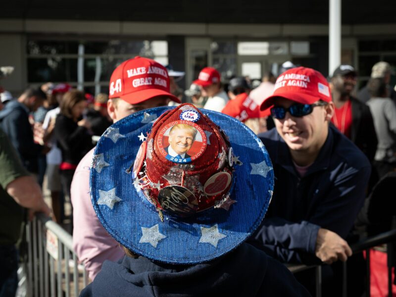 Photo of Donald Trump supporters with MAGA hats and a Donald Trump cowboy hat in Atlanta on the first day of early voting.